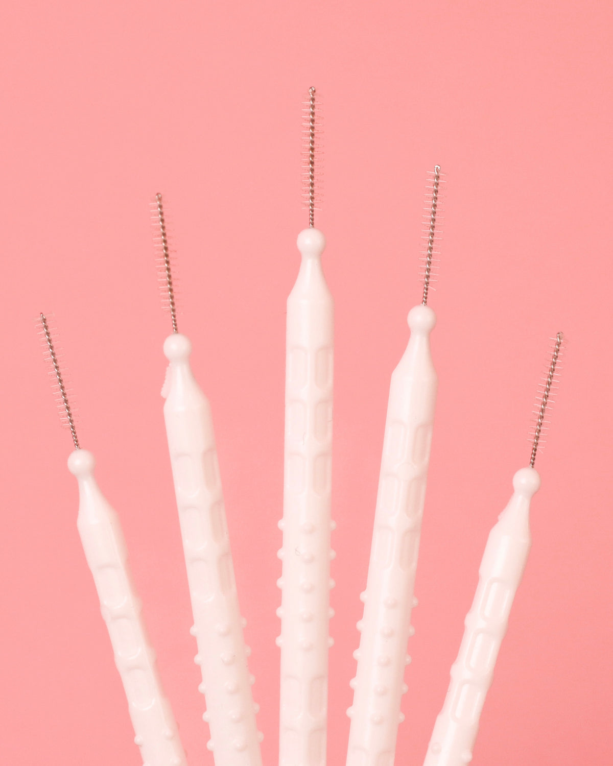 Interbrow Lamination Brushes on a pink background