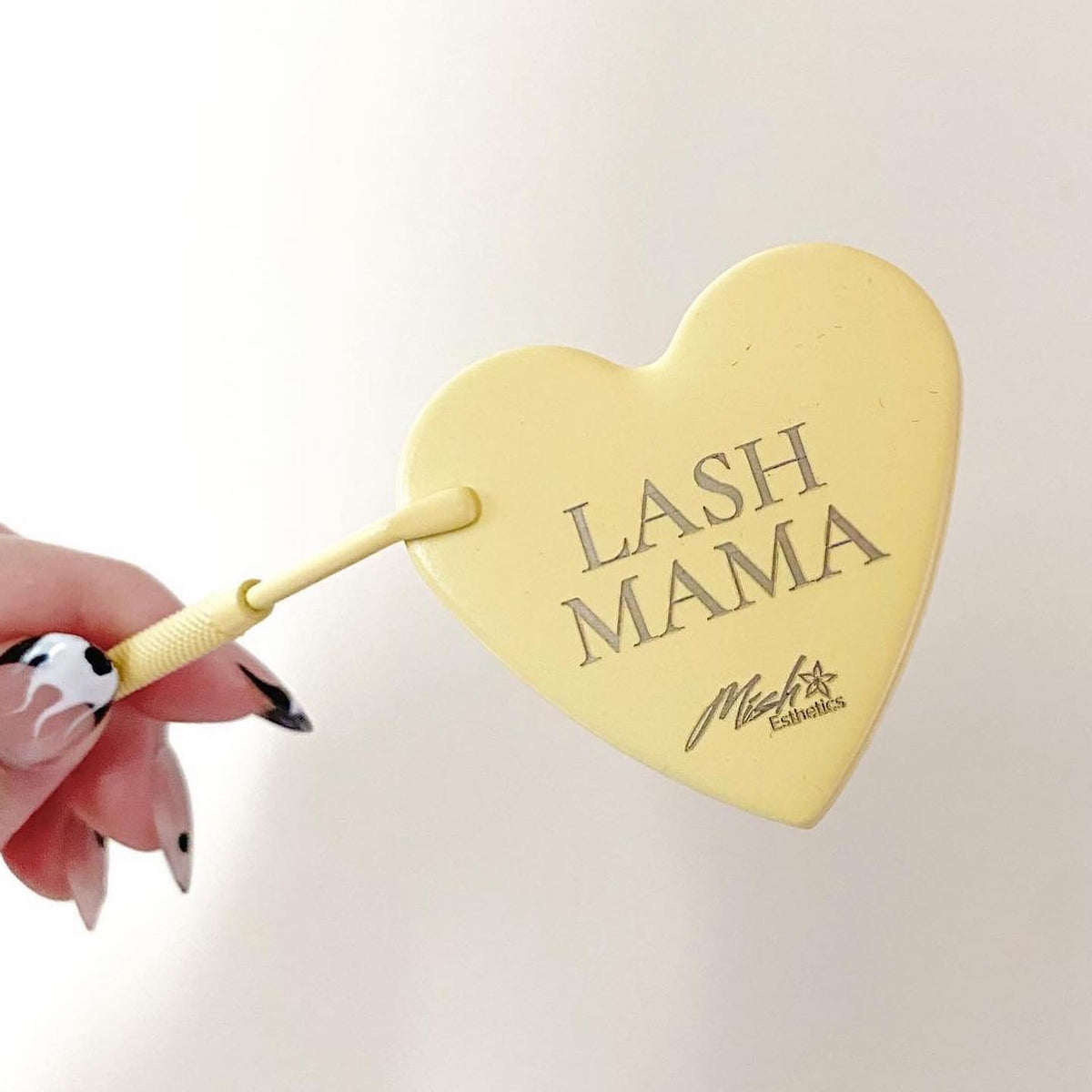 Lash Mama Mirror in yellow held in hand