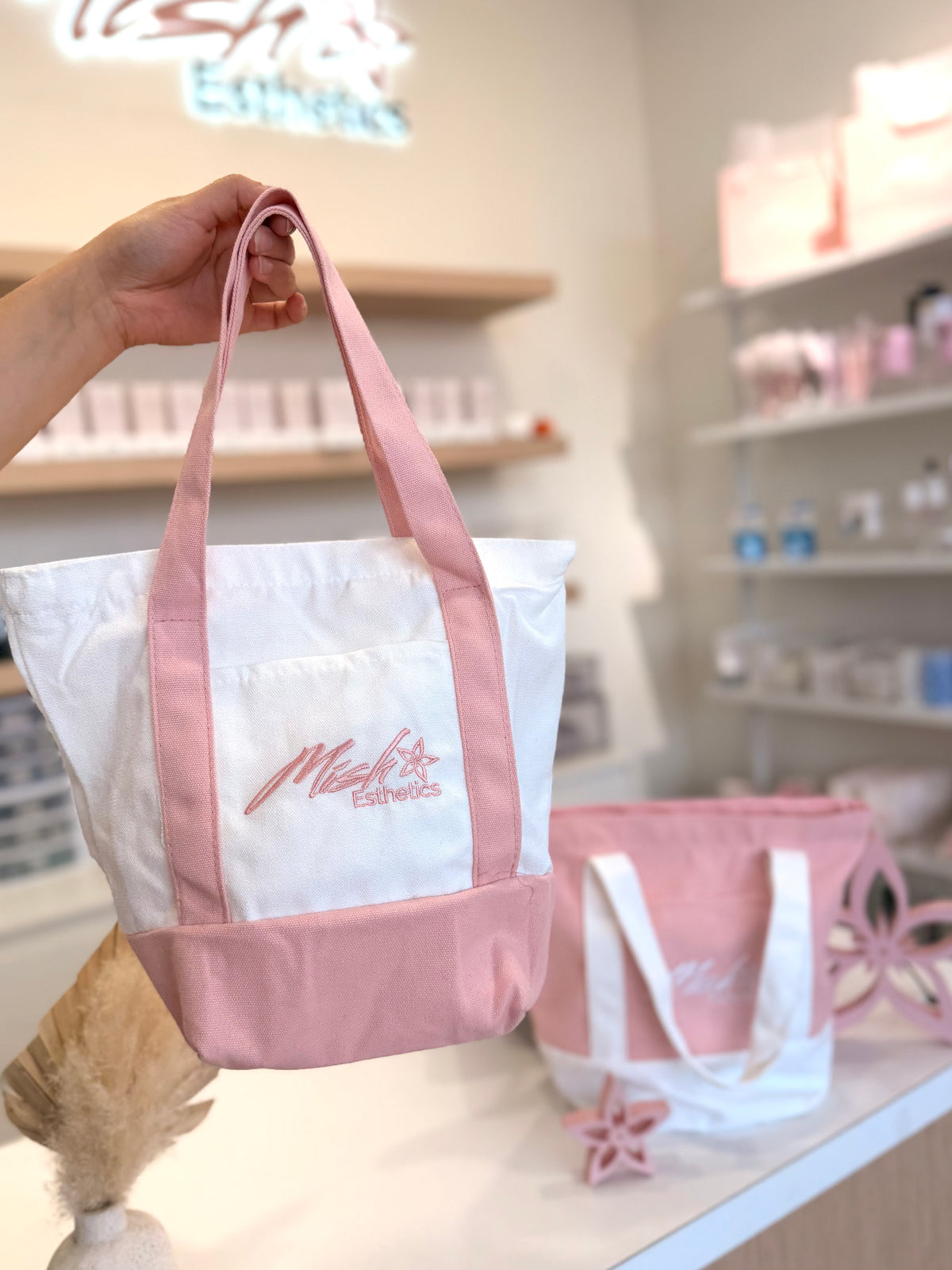 Trader Mish's Tote Bags held up in the Mish Esthetics studio